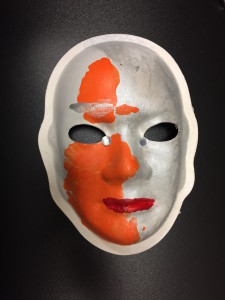 Unmasking Brain Injury mask painted silver and orange