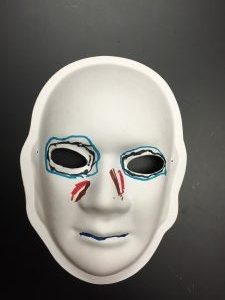 Unmasking Brain Injury mask painted with blue and red