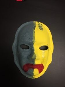 Unmasking Brain Injury mask painted black and yellow