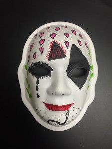 Unmasking Brain Injury mask painted with hearts and facial features