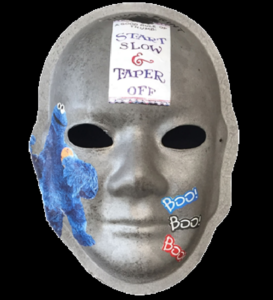 Unmasking Brain Injury mask painted silver with cookie monster and text