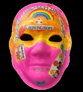 Unmasking Brain Injury mask painted pink and orange with text and a rainbow