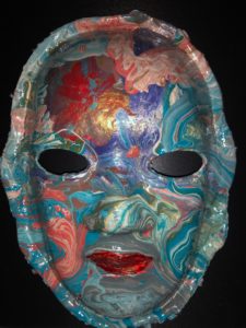 Unmasking Brain Injury mask painted with multicolored swirly metallic paint
