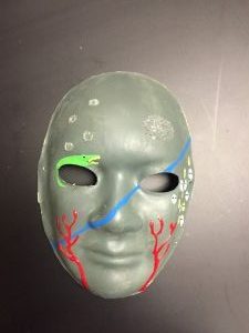 Unmasking Brain Injury mask painted gray with blue, red and green