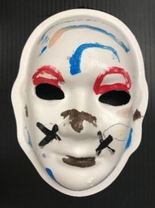 Unmasking Brain Injury mask painted with blue, red and black