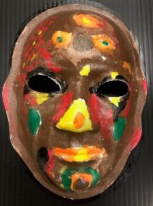 Unmasking Brain Injury mask painted brown with green, yellow and red splotches