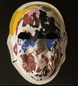 Unmasking Brain Injury mask painted with multicolored splotches