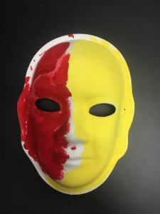 Unmasking Brain Injury mask painted part red and part yellow