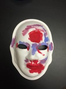 Unmasking Brain Injury mask painted red, purple and blue