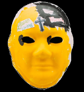 Unmasking Brain Injury mask painted yellow with a small black segment and a cross and text