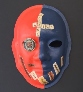 Unmasking Brain Injury mask painted blue and red with text on top