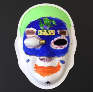 Unmasking Brain Injury mask painted blue, green and red with a light bulb