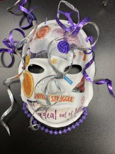 Unmasking Brain Injury mask with magazine images collaged on with text and ribbons