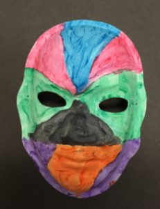 Unmasking Brain Injury mask painted blue, red, green, black, orange and purple
