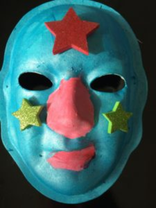 Unmasking Brain Injury mask painted blue with stars on the forehead and cheeks and red nose and lips