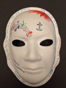 Unmasking Brain Injury mask painted with musical notes