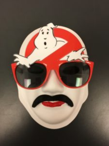 Unmasking Brain Injury mask painted with the ghostbusters logo and wearing large red sunglasses