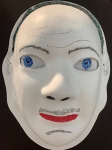 Unmasking Brain Injury mask painted with facial features