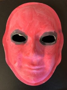 Unmasking Brain Injury mask painted red with black around eyes