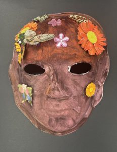 Unmasking Brain Injury mask painted red with butterflies and flowers