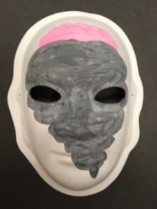Unmasking Brain Injury mask painted with black and pink