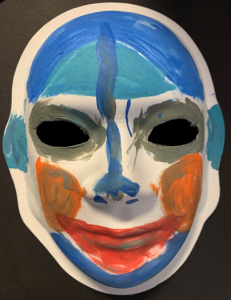 Unmasking Brain Injury mask painted with blue and red