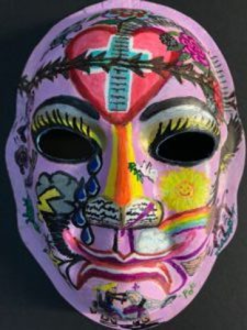 Unmasking Brain Injury mask painted purple with an elaborate design on top