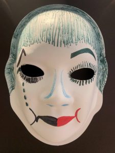 Unmasking Brain Injury mask painted with facial features and hair