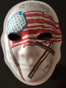 Unmasking Brain Injury mask painted with an American flag and a cross