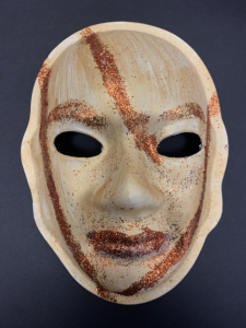 Unmasking Brain Injury mask painted copper with darker copper stripes