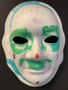 Unmasking Brain Injury mask painted with green around the eyes and upper lip