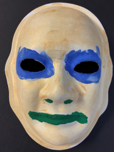 Unmasking Brain Injury mask painted with blue on the eyes and green on the lips
