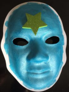 Unmasking Brain Injury mask painted blue with a yellow star on the forehead