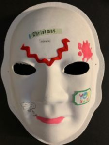 Unmasking Brain Injury mask with text, lips and some abstract lines painted on
