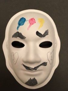 Unmasking Brain Injury mask painted blue, red, yellow and black
