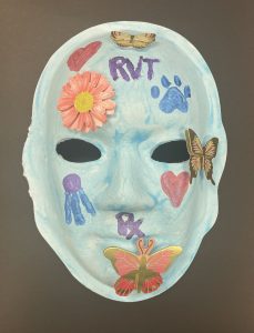 Unmasking Brain Injury mask painted blue with butterflies and flowers