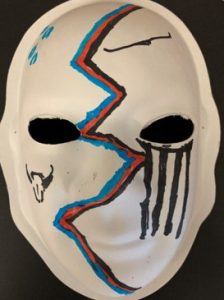 Unmasking Brain Injury mask painted with a red and blue zig zag and black lines