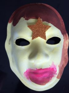Unmasking Brain Injury mask painted with different shades of purple and a large star on the forehead