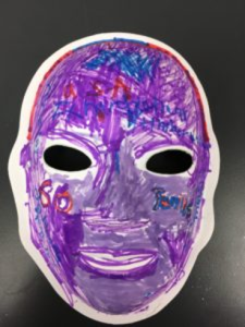 Unmasking Brain Injury mask painted purple with red and blue lines