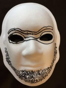 Unmasking Brain Injury mask painted with a beard and glasses