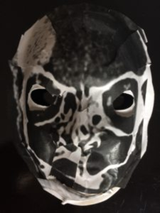 Unmasking Brain Injury mask painted black and white