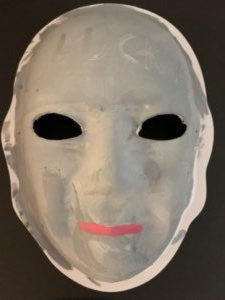 Unmasking Brain Injury mask painted gray with pink lips