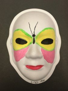 Unmasking Brain Injury mask painted with a large butterfly