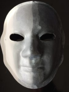 Unmasking Brain Injury mask painted white with a gradient from white to black
