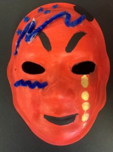 Unmasking Brain Injury mask painted orange with black, blue and gold design