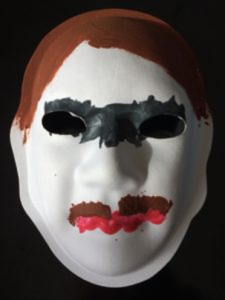 Unmasking Brain Injury mask painted with hair, lips and a mustache