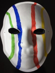 Unmasking Brain Injury mask painted white with green, blue, red and yellow lines