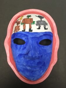 Unmasking Brain Injury mask painted blue and white with people on the forehead