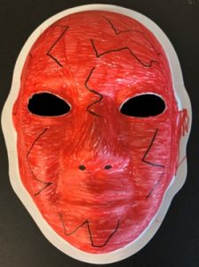Unmasking Brain Injury mask painted red with black lines