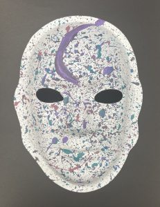 Unmasking Brain Injury mask painted with splattered purple paint